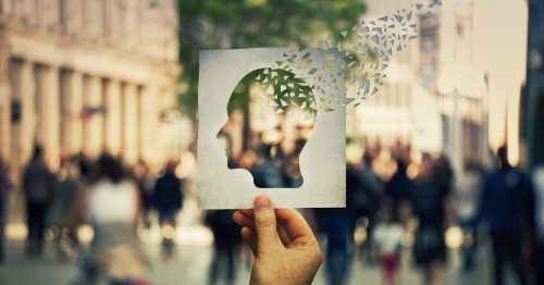 Ilustración de un recorte de papel simulando a una persona perdiendo la memoria por Alzheimer